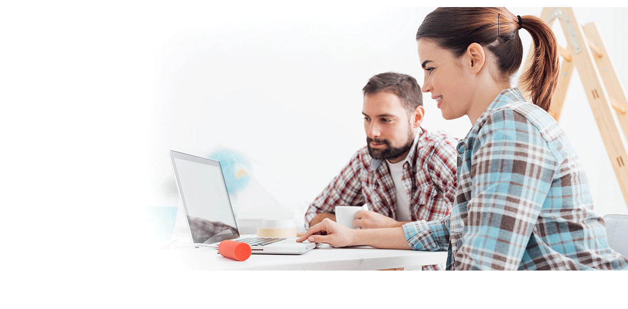 couple looking at laptop planning home remodeling