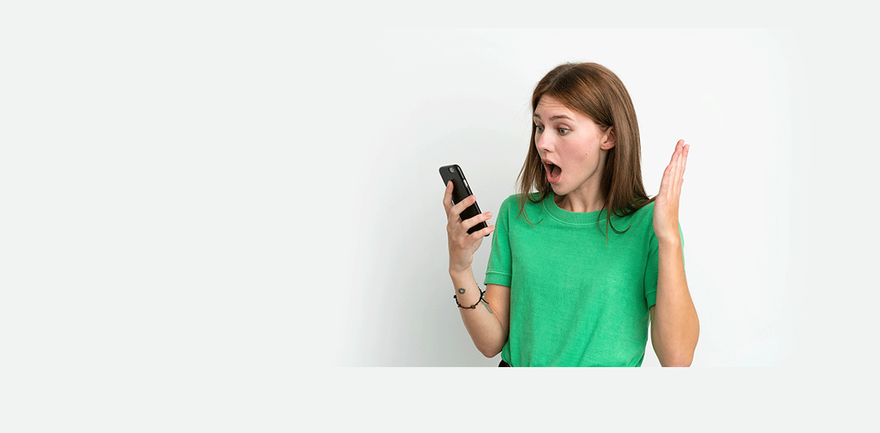 girl looking at her phone with an astonished face and her hand in the air.