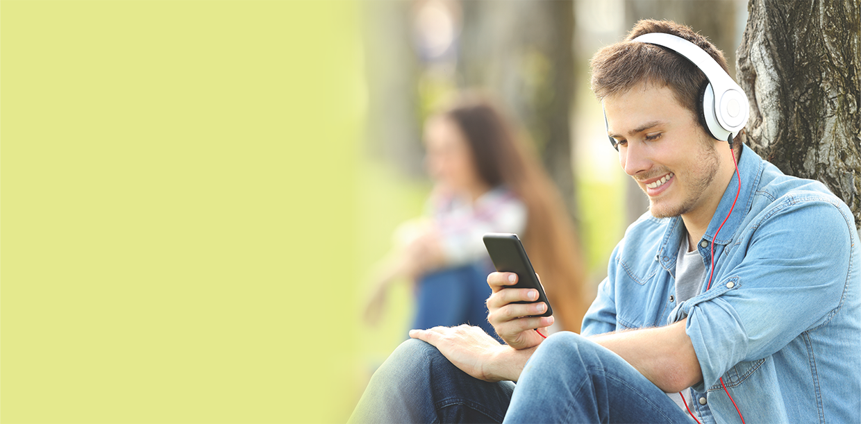 man outside listening to headphones