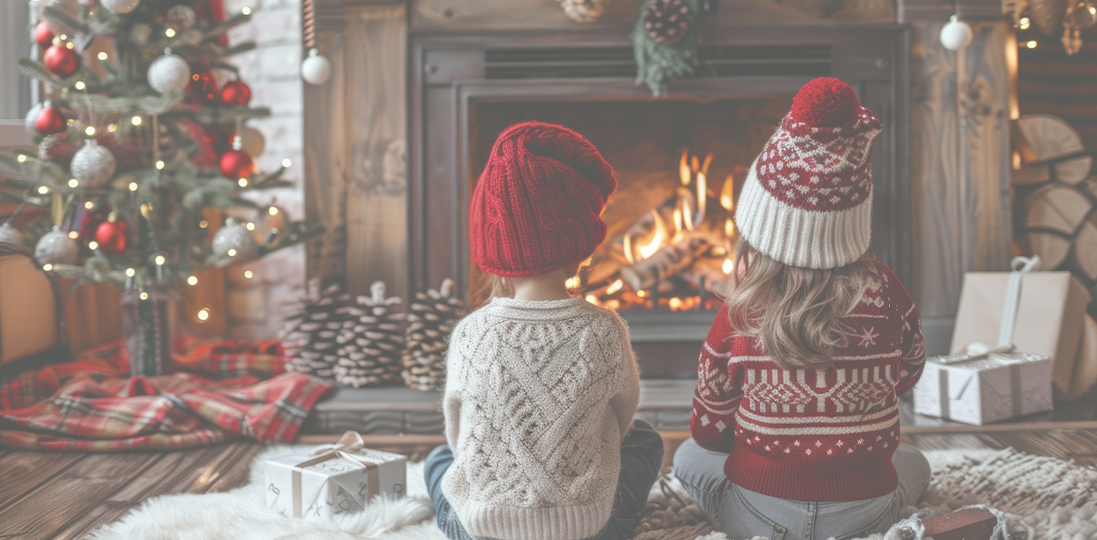 children by a cozy fireplace at christmastime